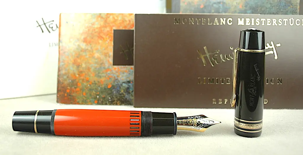 Red fountain pen with black cap.