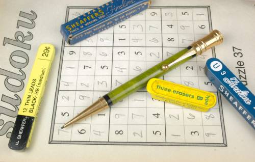 Sudoku puzzle with vintage pencil and erasers.